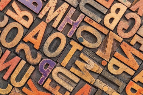 Wood type alphabet abstract with a grunge texture - letterpress printing blocks stained by color
