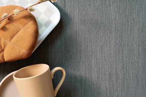 Kitchenware mug cup, dish, gloves, tray on gray fabric background. top view, copy space