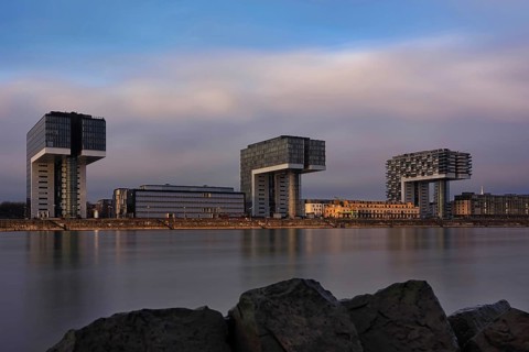 View over the Rhine with crane houses, sunrise, long exposure, Cologne, Germany