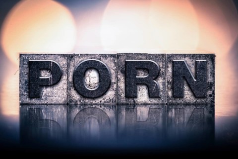 The word PORN written in vintage ink stained letterpress type