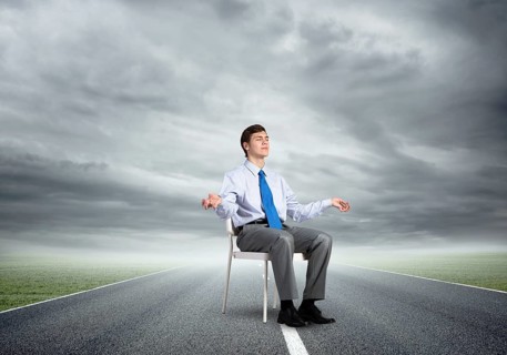 Businessman sitting on an office chair, meditation and calmness