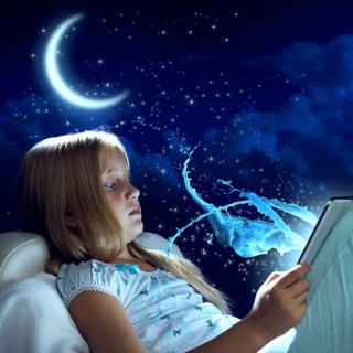 Girl sitting in bed and using her tablet pc