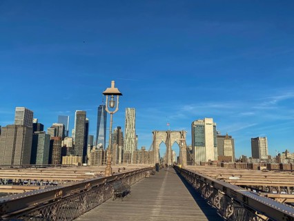 Straight view of the Brooklyn Bridge with skyscrapers and clear sky in the background, New York,