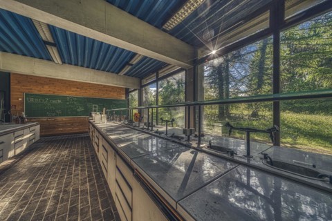 Sunlit, abandoned laboratory with old lab benches and a view of the countryside, Institute of