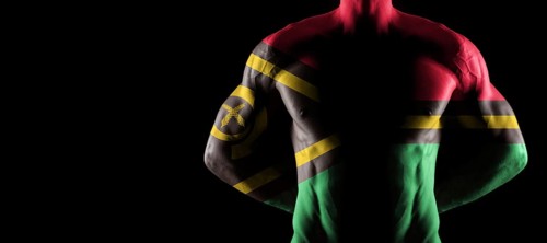 Vanuatu flag on muscled male torso with abs, black background