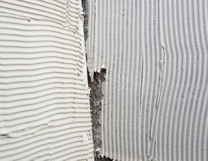 Construction notched trowel mortar shape on big tile back side