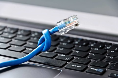 Internet cable with knot on a computer keyboard