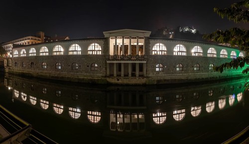 Iconic building of the central market in Ljubljana illuminated at night, Slovenia