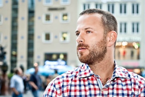 An image of a handsome man with a beard in the city