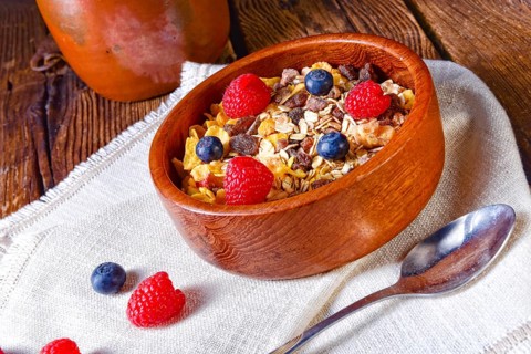 Rustic muesli breakfast with forest fruits