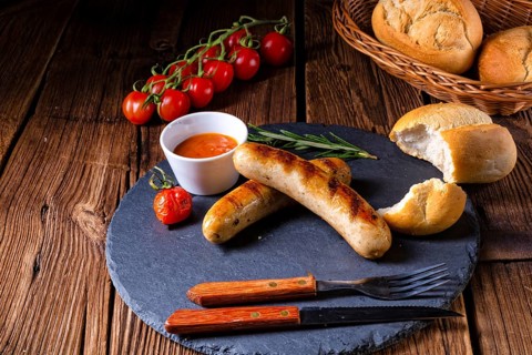 Rustic bratwurst with ketchup and fresh rolls
