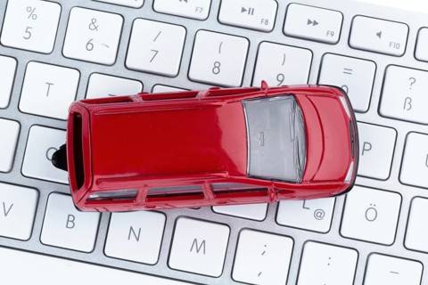 Car on keyboard, symbol photo for car purchase and car trade on the Internet