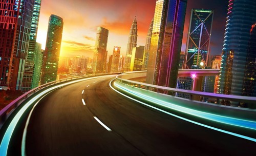 Autobahnüberführung Bewegungsunschärfe mit Stadtsilhouette und städtischen Wolkenkratzern