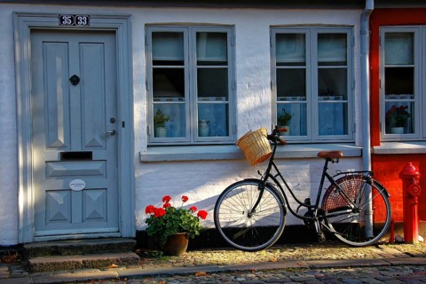 House entrance, Odense, Denmark, Europe, Black bicycle rests against an old house with floral