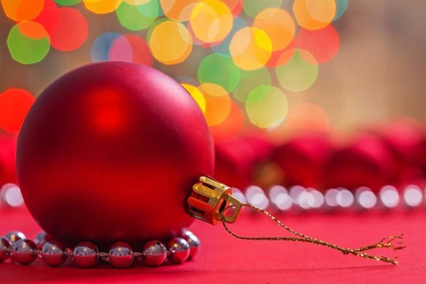 Big red christmas ball on red background horizontal version