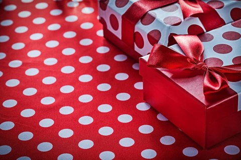 Christmas gifts on polka-dot red textile celebrations concept