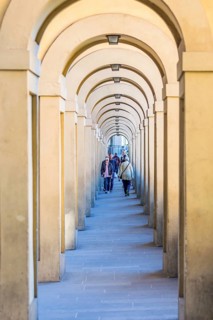 Vasari Corridor with tourists in Florence, Italy