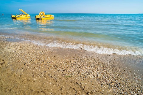 Yellow lifeboat on the beach. Italian beach
