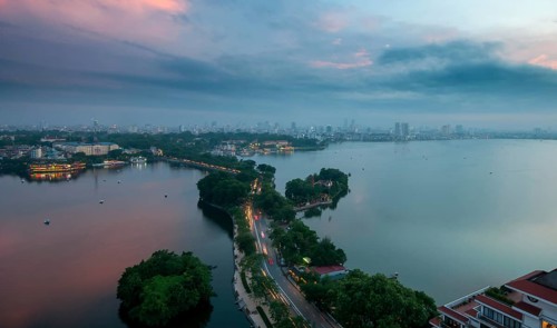 The skyline of Hanoi, the capital city of Vietnam and the Hoan Kiem lake during a colorful sunset