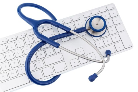 Stethoscope and keyboard of a computer, symbolic photo for diagnostics and appointment management