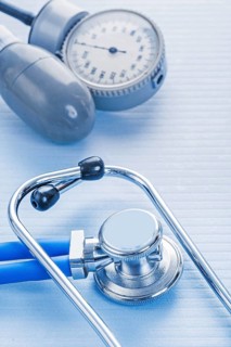 Stethoscope and blood pressure monitor on blue background medical concept