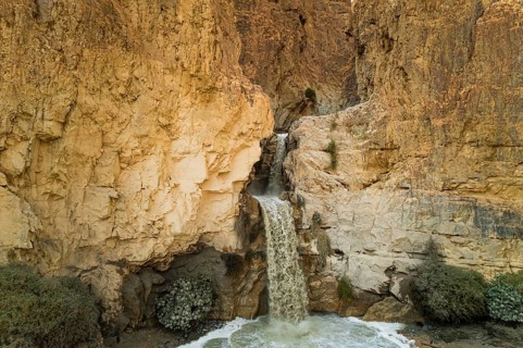 Unexpected powerful waterfall in the Judean Desert around the Dead Sea after heavy winter rains.