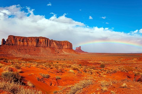 Navajo Indian Reservations. USA. Monument Valley Sentinel Mesa and the bright rainbow. Monument