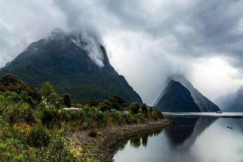 Magic country of fantastic heroes. New Zealand. Storm clouds cover the sky over the famous ocean