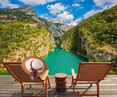 Travel across Provence. Two wooden chaise lounges on platform at the lake Verdon