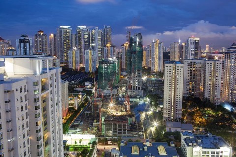 Construction works in residential area of Kuala Lumpur with high-rise apartment blocks. City