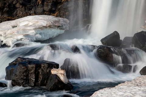 Water from waterfall splashing on a rocky river. The Oxararfoss waterfall in pingvellir Thingvellir