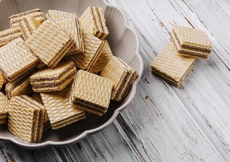 Food, Crisp layered wafers are neatly arranged in a bowl, their patterns creating an inviting look.