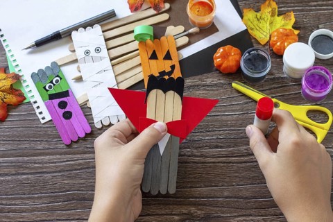 Instructions, step 6. Halloween ghost and vampire toy gift stics puppets on wooden table. Handmade.