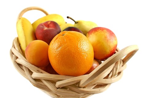 Cane basket filled with freshly picked colorful organic fruit