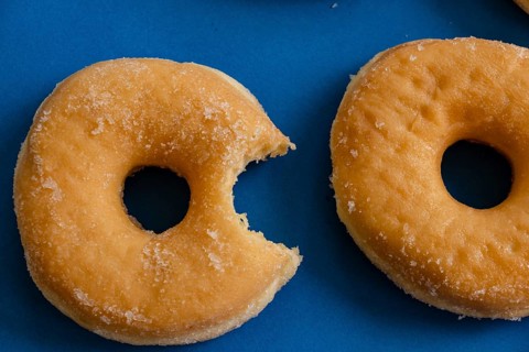 Bitten donut on blue background
