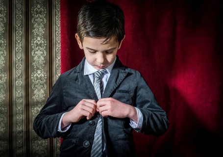 Boy in vintage black suit and tie