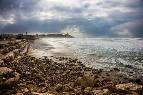 The storm in the Mediterranean Sea. Huge foaming waves beating against the shore. New Quay in the