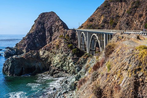 Great arch viaduct runs along the Pacific coast. California highway number 1. USA
