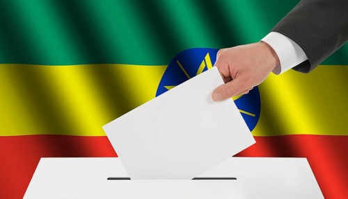The Ethiopia flag and the hand with the bulletin about the ballot box
