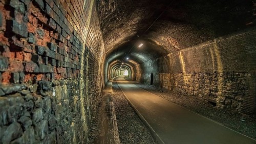 Walking through the Headstone Tunnel, near Monsal Head in the East Midlands, Derbyshire, Peak
