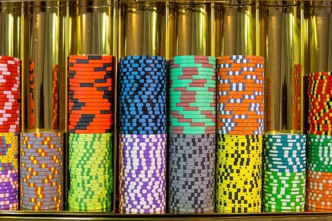 Colourful roulette chips in a casino on a gambling table. Lots of chips with different nomination