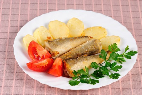 Fried fish and potato dinner on the table