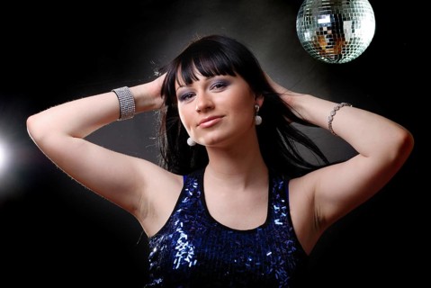 Girl in the nightclub is dancing in lights