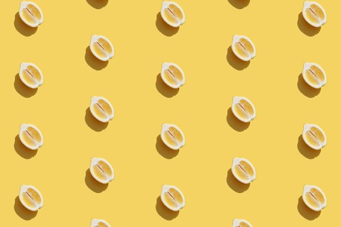 Conceptual pattern with halves of lemon collection with shadow on yellow background. Healthy