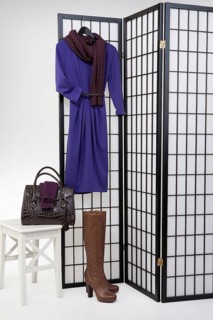 Woman's clothing and accessories on checkered folding screen
