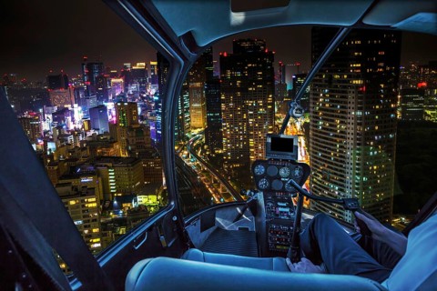 Helicopter flying over Tokyo cityscape and Shiodome skyscrapers and business offices view from