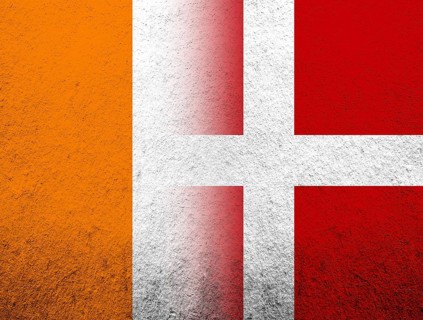 The Kingdom of Denmark National flag with Ivory Coast National flag. Grunge Background