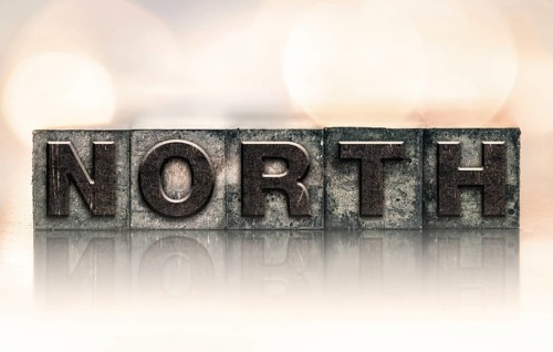 The word NORTH written in vintage ink stained letterpress type