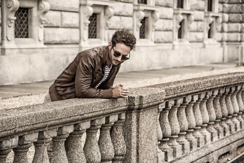 Attractive young man outdoor wearing leather jacket, in European city, Turin in Italy