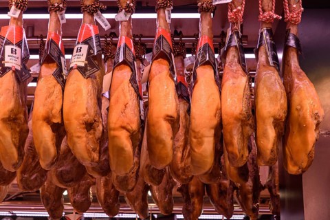 The stalls selling Jamón Serrano, the dry-cured Spanish ham made with Iberian pigs, in Barcelona,